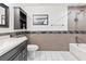 Well-lit bathroom featuring a shower-tub combo, custom tile work, and a modern vanity at 418 Acacia Cir, Port Orange, FL 32127