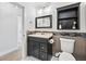 Updated bathroom features a vanity, updated tile, toilet, decorative mirror, and modern lighting at 418 Acacia Cir, Port Orange, FL 32127