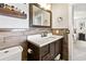 Bathroom vanity with dark cabinets, a bright countertop, and attractive wood backsplash at 418 Acacia Cir, Port Orange, FL 32127