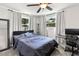 Bedroom featuring gray walls, two windows, a bed and a desk at 418 Acacia Cir, Port Orange, FL 32127