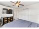 Bedroom featuring a ceiling fan, television, closet and view of ensuite bathroom at 418 Acacia Cir, Port Orange, FL 32127