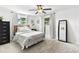 Bright bedroom with neutral tones, a ceiling fan, and two windows providing natural light at 418 Acacia Cir, Port Orange, FL 32127
