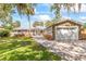 Charming single-story home with a paver driveway, attached garage, lush landscaping and beautiful curb appeal at 418 Acacia Cir, Port Orange, FL 32127