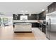 Spacious kitchen boasts dark cabinets, stainless appliances, granite countertops, island and seamless access to outdoor pool at 418 Acacia Cir, Port Orange, FL 32127