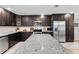 Bright kitchen featuring stainless appliances, granite counters, dark wood cabinets, and ample counter space at 418 Acacia Cir, Port Orange, FL 32127