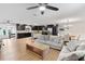 Open concept living room with hardwood floors, dining area and dark cabinets in the kitchen area at 418 Acacia Cir, Port Orange, FL 32127