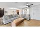 Bright living room with cozy seating, light wood floors, a ceiling fan and view into the dining room at 418 Acacia Cir, Port Orange, FL 32127