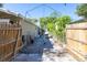 View of the side yard featuring a brick-paved walkway, storage shed, and wooden fence at 418 Acacia Cir, Port Orange, FL 32127