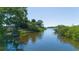 Inviting water view from the property surrounded by lush greenery and calming atmosphere at 418 Acacia Cir, Port Orange, FL 32127