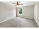 Bedroom with neutral carpet, ceiling fan, and a bright window at 4209 Sw 33Rd St, Ocala, FL 34474