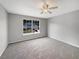 Bedroom with neutral carpet, ceiling fan, and a large window at 4209 Sw 33Rd St, Ocala, FL 34474