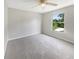 Bright bedroom with neutral carpet, ceiling fan, and a bright window at 4209 Sw 33Rd St, Ocala, FL 34474