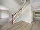 Inviting entryway with wood-look flooring, staircase and a view to the bright and airy living spaces at 4209 Sw 33Rd St, Ocala, FL 34474