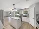 Modern kitchen with stainless appliances, island with pendant lighting, and seamless transition to living spaces at 4209 Sw 33Rd St, Ocala, FL 34474