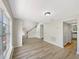 Bright living room with wood-look flooring, staircase, and large window provides a welcoming atmosphere at 4209 Sw 33Rd St, Ocala, FL 34474