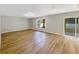 Spacious living room with wood-look flooring and sliding glass doors to the patio provides ample natural light at 4209 Sw 33Rd St, Ocala, FL 34474