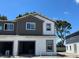 New construction townhome showcasing a two-tone paint scheme, garage and new windows at 4240 Campsite Loop, Orlando, FL 32824