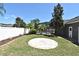 Spacious backyard features a brick patio, well-maintained lawn, and tropical landscaping at 436 Skyview Pl, Chuluota, FL 32766
