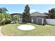 Spacious backyard with a brick patio, storage shed, green grass, and tropical landscaping at 436 Skyview Pl, Chuluota, FL 32766