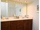 Bright bathroom featuring a large mirror, recessed lighting, and double vanity sink with wooden cabinets at 436 Skyview Pl, Chuluota, FL 32766