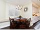 Dining area with a banquette, table, and window, complemented by nearby kitchen features at 436 Skyview Pl, Chuluota, FL 32766