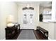 Bright entryway features decorative glass doors, hardwood floors, and stylish accents at 436 Skyview Pl, Chuluota, FL 32766