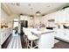 Spacious kitchen featuring a large island with seating, white cabinetry, stainless steel appliances, and pendant lighting at 436 Skyview Pl, Chuluota, FL 32766