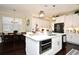 Bright kitchen with a central island, white cabinets, stainless appliances, and an adjacent dining space at 436 Skyview Pl, Chuluota, FL 32766