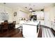 Bright kitchen showcasing an island with seating, white cabinetry, stainless appliances, and an adjacent dining area at 436 Skyview Pl, Chuluota, FL 32766