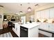 Open-concept kitchen with a central island, stainless steel appliances, and a view into the living area at 436 Skyview Pl, Chuluota, FL 32766