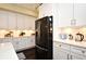 Contemporary kitchen featuring stainless steel appliances, sleek black refrigerator and ample storage at 436 Skyview Pl, Chuluota, FL 32766