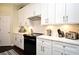 Bright kitchen with white cabinetry, quartz countertops, stainless steel appliances, and under-cabinet lighting at 436 Skyview Pl, Chuluota, FL 32766