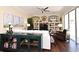 Bright living room with hardwood floors, ceiling fan, and built-in shelving with decorations and adjacent to glass sliding doors at 436 Skyview Pl, Chuluota, FL 32766
