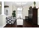 Bright living room features hardwood floors, a modern chandelier, and large windows at 436 Skyview Pl, Chuluota, FL 32766