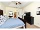 Carpeted bedroom features a vaulted ceiling and leads to the bathroom and an outdoor area at 436 Skyview Pl, Chuluota, FL 32766