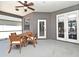 Covered patio features lovely outdoor seating, ceiling fan, and convenient backyard access at 436 Skyview Pl, Chuluota, FL 32766
