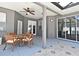 Covered patio features comfortable outdoor seating, a ceiling fan, and backyard access at 436 Skyview Pl, Chuluota, FL 32766