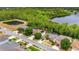 A lovely aerial view of homes near a tranquil lake, surrounded by lush green trees at 447 Kehoe Blvd, Orlando, FL 32825