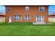 Large backyard featuring a lush green lawn, a neutral home exterior, and a white fence at 447 Kehoe Blvd, Orlando, FL 32825