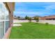 Expansive backyard with lush green grass, a concrete slab, and a white privacy fence at 447 Kehoe Blvd, Orlando, FL 32825