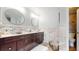 Bathroom with dual vessel sinks, marble walls, wood-look floors, and plenty of storage at 447 Kehoe Blvd, Orlando, FL 32825