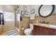 Bathroom with granite countertop, dark wood cabinets, and a walk-in shower with a glass door and exterior door at 447 Kehoe Blvd, Orlando, FL 32825
