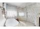 Bright bathroom with a soaking tub, glass-enclosed shower, and elegant marble accents at 447 Kehoe Blvd, Orlando, FL 32825