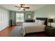 Well-lit bedroom with modern gray accents, a comfortable bed, and hardwood floors at 447 Kehoe Blvd, Orlando, FL 32825