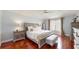 This bedroom features a large bed, hardwood floors and plenty of natural light from the window at 447 Kehoe Blvd, Orlando, FL 32825