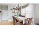 Charming dining room with a rustic wooden table and decorative chandelier, perfect for Gathering meals at 447 Kehoe Blvd, Orlando, FL 32825