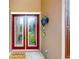 Inviting entryway features a decorative glass door and stylish wall sconce, perfect for welcoming guests at 447 Kehoe Blvd, Orlando, FL 32825
