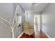 Welcoming hallway with a decorative mirror, chair, hardwood floors, and neutral paint at 447 Kehoe Blvd, Orlando, FL 32825