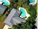 Aerial view of home showcasing a large swimming pool and lush backyard at 5096 The Oaks Cir, Orlando, FL 32809