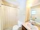 Bright bathroom featuring a shower-tub combo with sliding curtain and a large mirror above the vanity at 5096 The Oaks Cir, Orlando, FL 32809